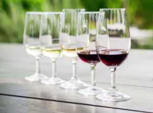 Five wine glasses with red and white wine