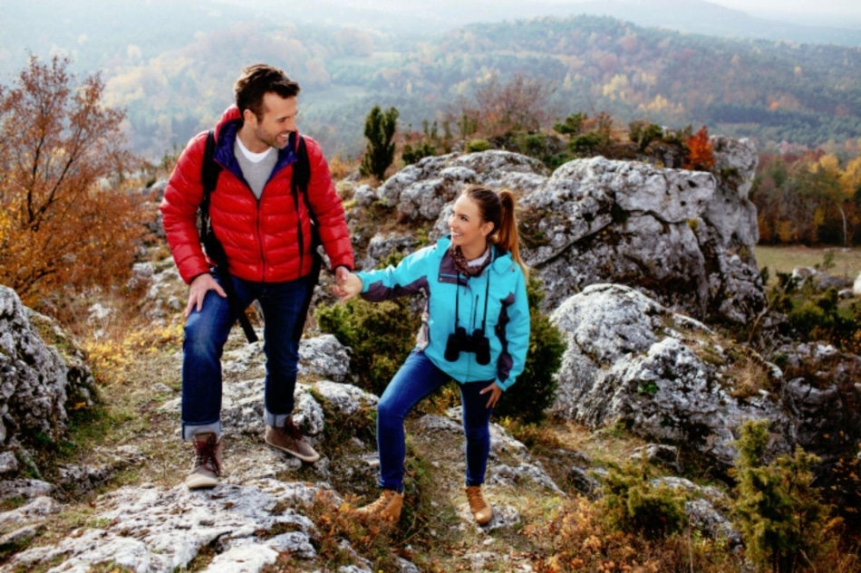 Couple hiking up mountain