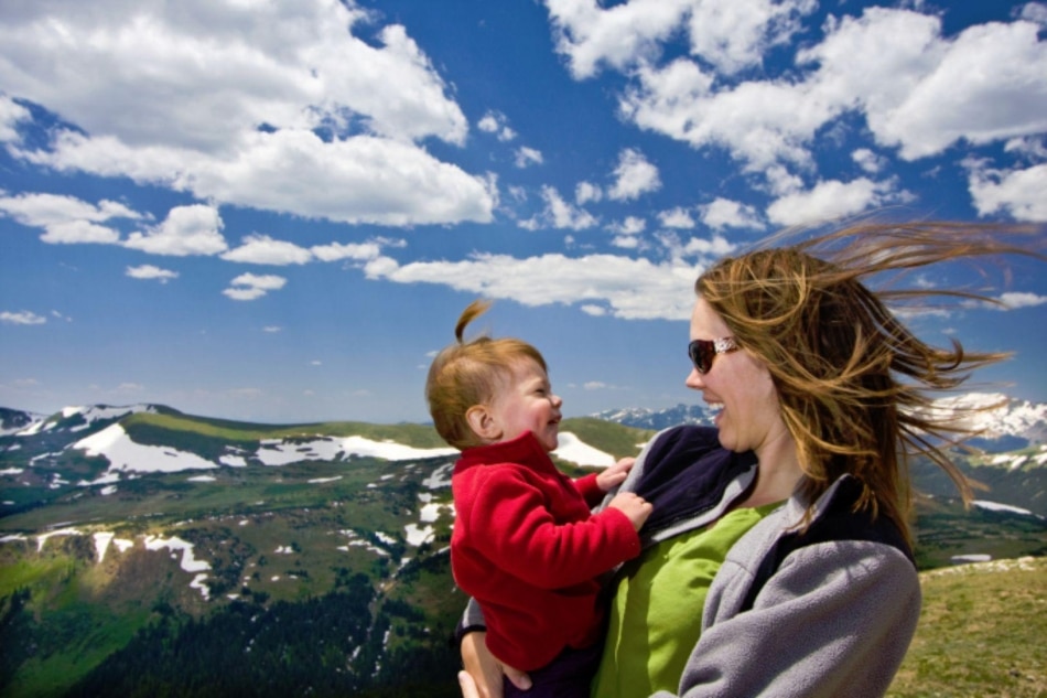 Mother holding son on mountain