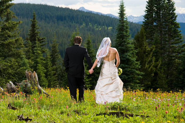 bride and groom holding hands for weddings in estes park