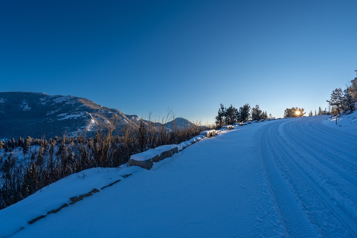 Snow covered road through the extreme winter terrain of Rocky Mountain National Park near Estes Park, Colorado USA.
