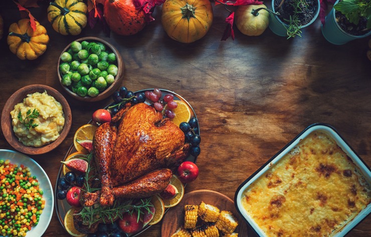 Preparing traditional stuffed turkey with side dishes for Thanksgiving holiday